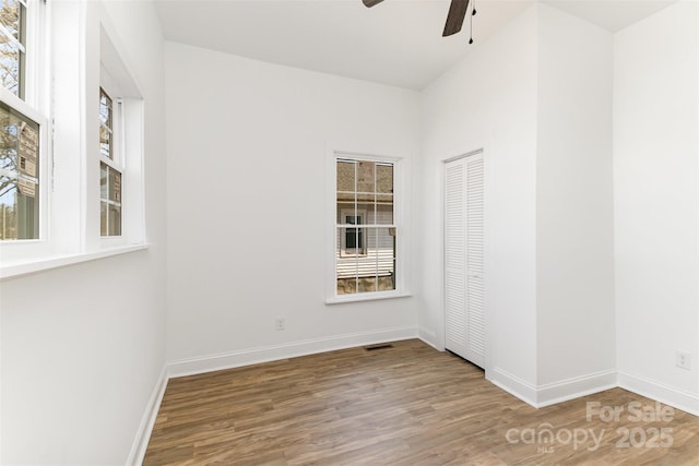 unfurnished room with hardwood / wood-style floors and ceiling fan