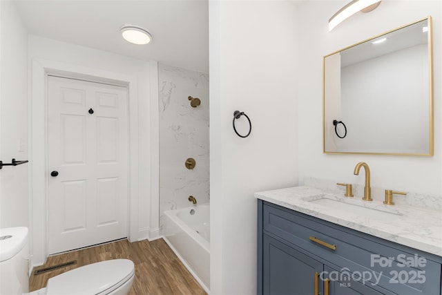 full bathroom featuring vanity, wood-type flooring, shower / washtub combination, and toilet