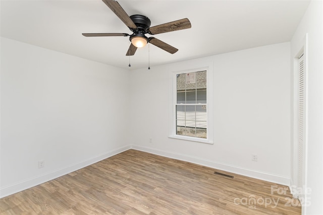 unfurnished room with light hardwood / wood-style flooring, ceiling fan, and a closet