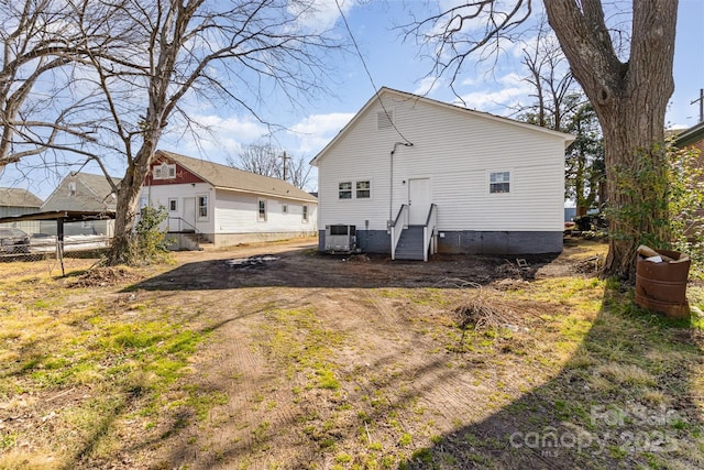 rear view of property featuring central AC