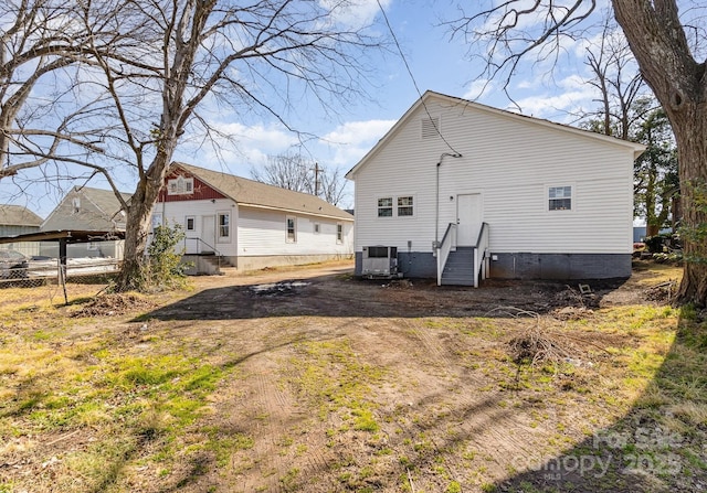 back of property featuring central AC unit