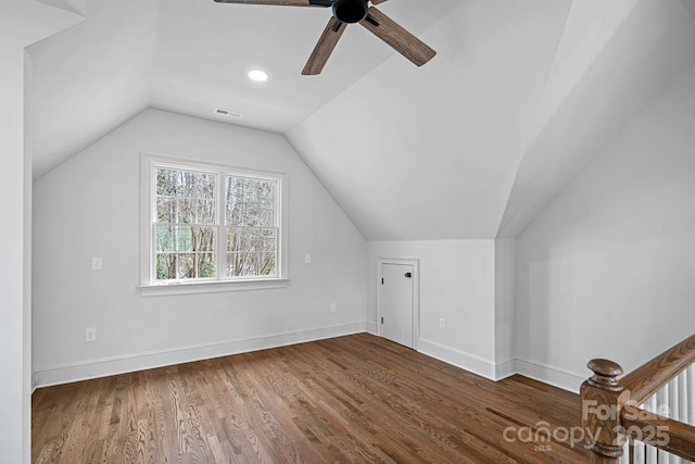 bonus room featuring vaulted ceiling, visible vents, baseboards, and wood finished floors