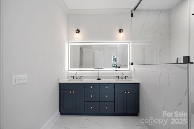 full bathroom featuring double vanity, marble finish floor, crown molding, and a sink