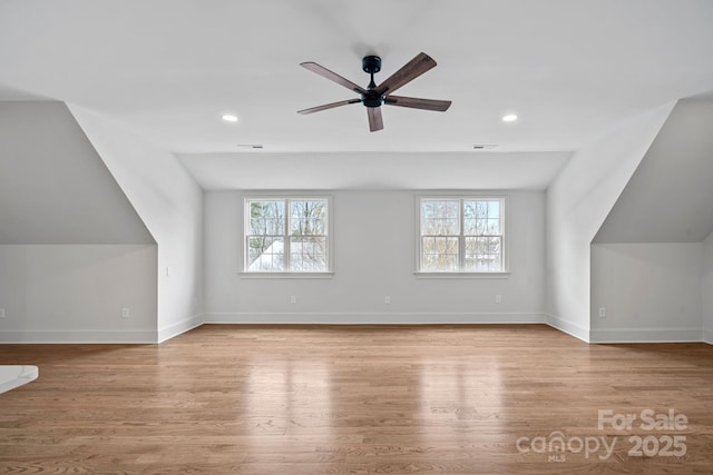 additional living space featuring visible vents, baseboards, and wood finished floors