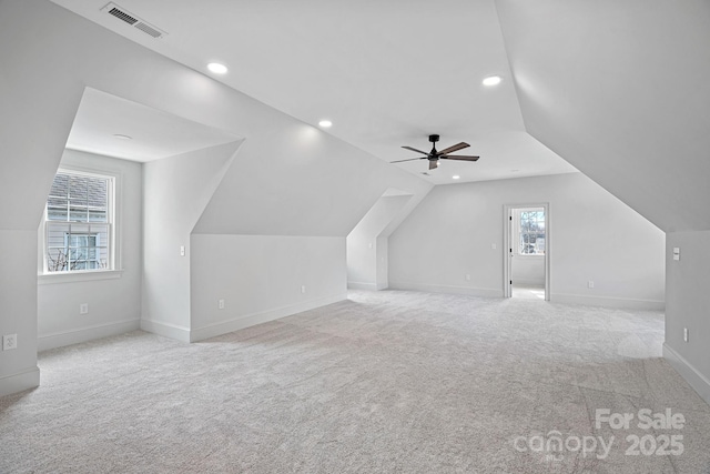 additional living space with visible vents, a ceiling fan, recessed lighting, carpet, and lofted ceiling