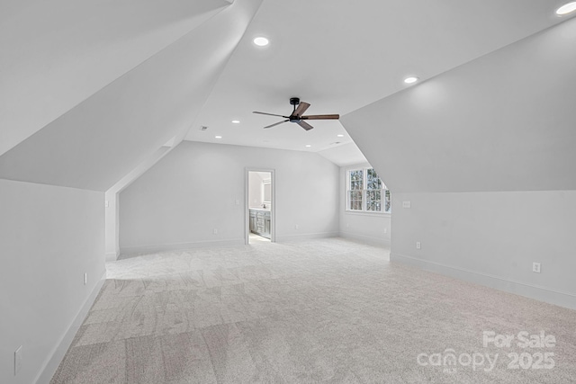 bonus room with lofted ceiling, carpet, and baseboards