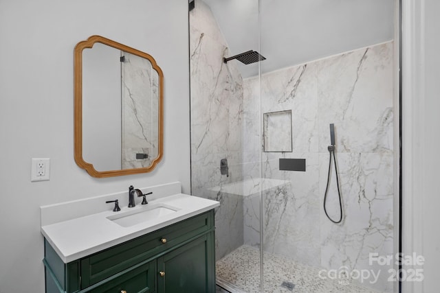 full bathroom featuring a marble finish shower and vanity