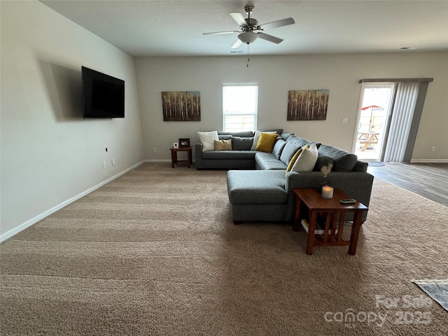 living room featuring ceiling fan, a healthy amount of sunlight, and carpet flooring