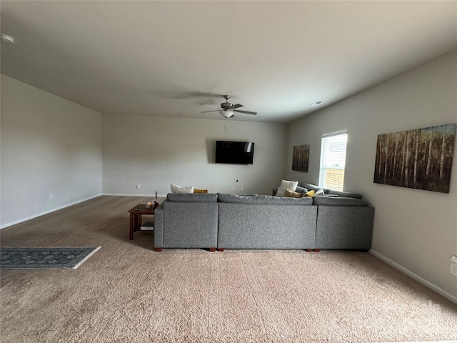 living room with ceiling fan and carpet