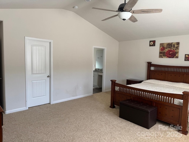 bedroom featuring ensuite bathroom, lofted ceiling, light colored carpet, and ceiling fan