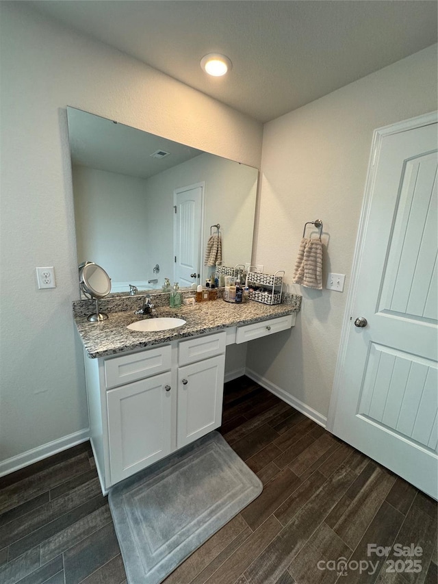 bathroom featuring vanity and hardwood / wood-style flooring