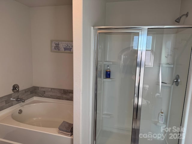 bathroom with shower with separate bathtub