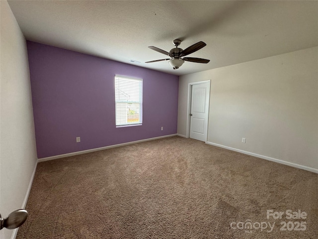 unfurnished bedroom featuring ceiling fan, a textured ceiling, and carpet