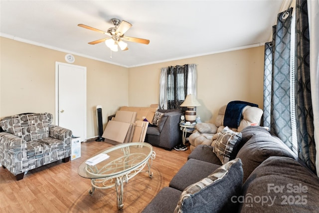 living room featuring crown molding, hardwood / wood-style flooring, and ceiling fan