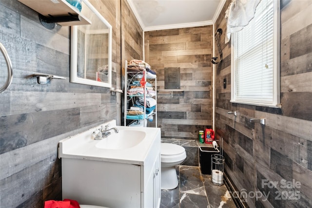 bathroom featuring vanity, toilet, and wood walls