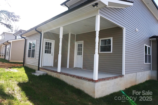 exterior space featuring a lawn and a porch