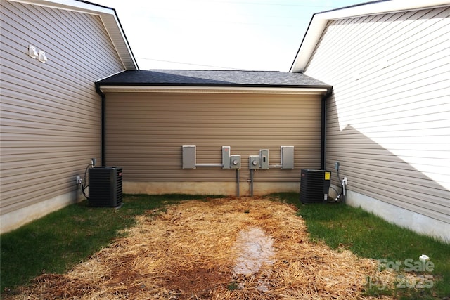 view of side of property with central AC unit