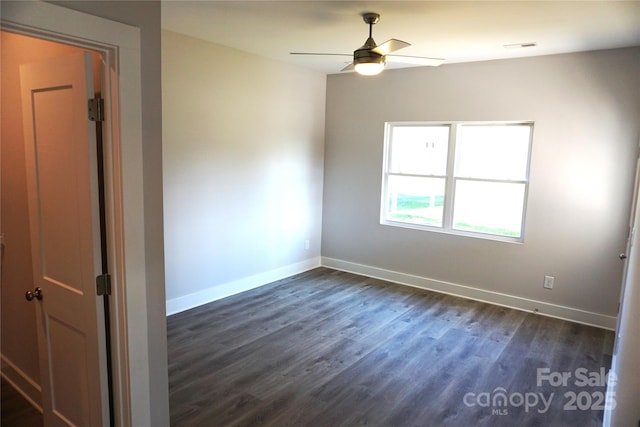 empty room with dark hardwood / wood-style floors and ceiling fan