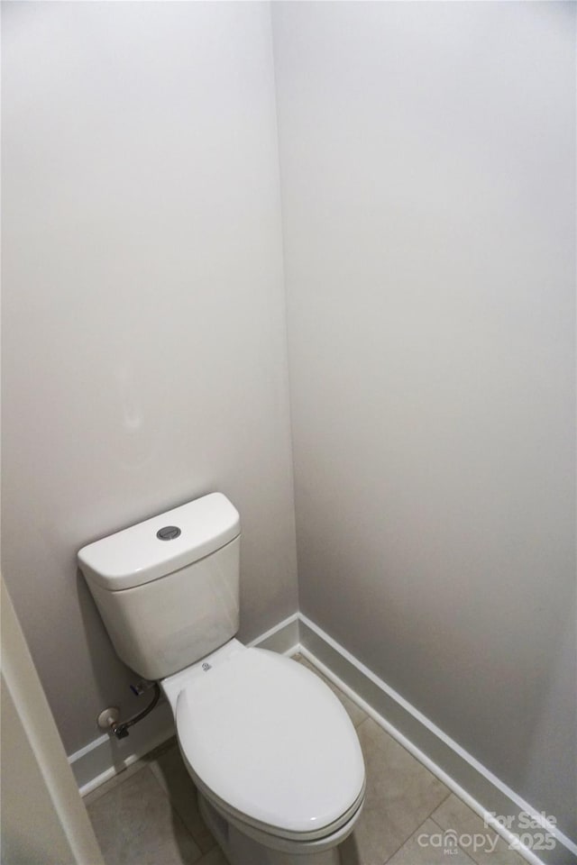 bathroom featuring tile patterned flooring and toilet