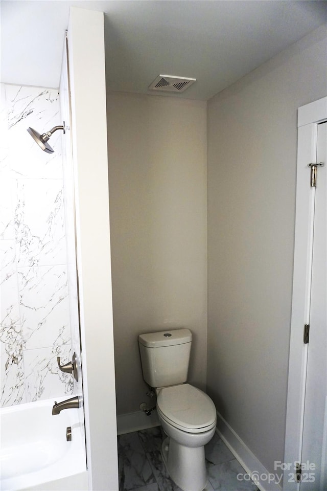 bathroom with tiled shower / bath and toilet