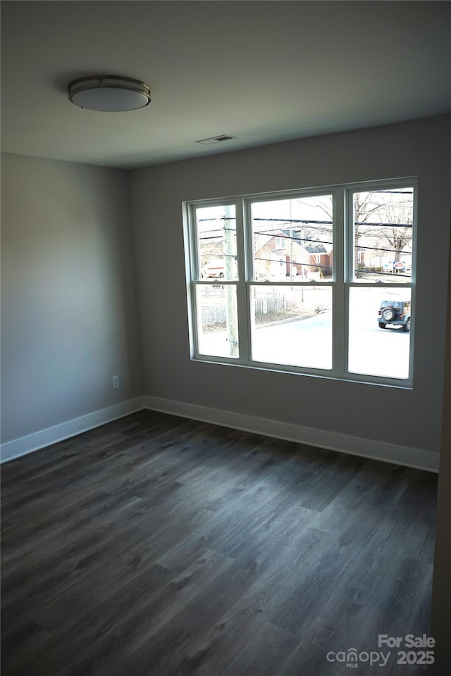 empty room featuring dark wood-type flooring