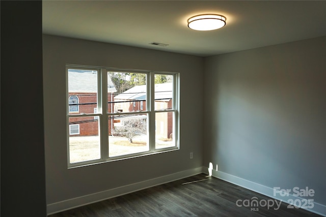 spare room with dark hardwood / wood-style flooring