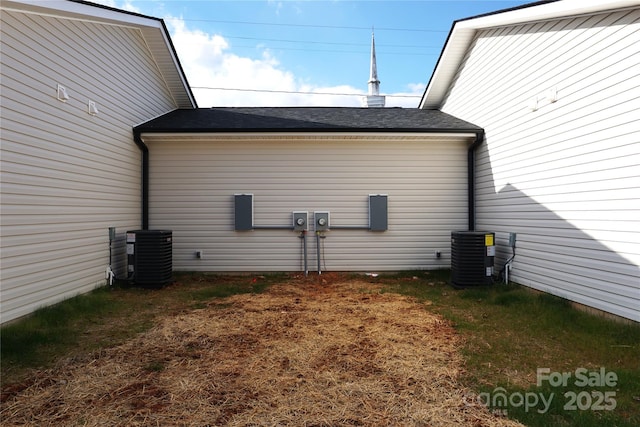 view of side of home with central air condition unit