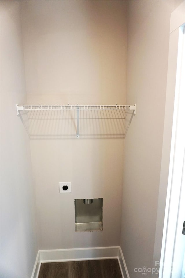 laundry area with electric dryer hookup and dark wood-type flooring