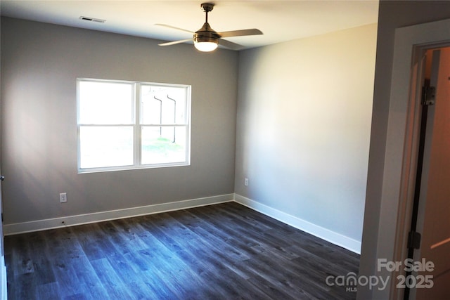 spare room with dark hardwood / wood-style floors and ceiling fan