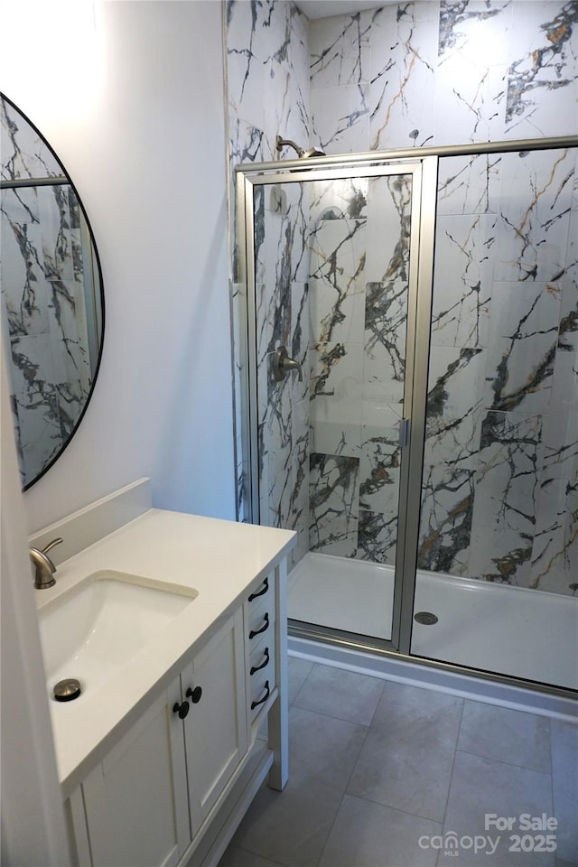 bathroom with vanity and a shower with door