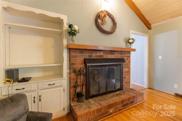 interior details with hardwood / wood-style flooring, ornamental molding, and a fireplace