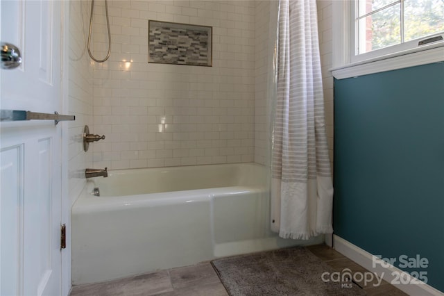 bathroom featuring shower / bathtub combination with curtain