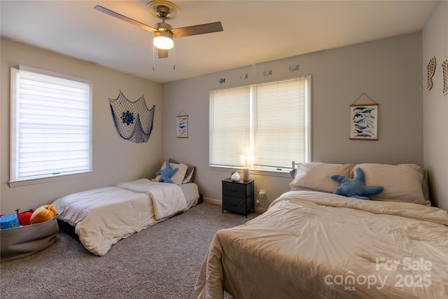 carpeted bedroom with multiple windows and ceiling fan