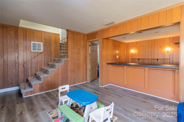 interior space featuring dark hardwood / wood-style floors and wood walls