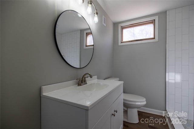 bathroom with vanity, toilet, and wood-type flooring