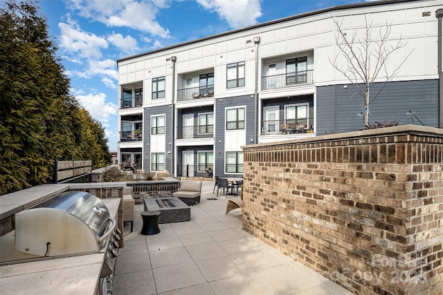 view of patio featuring area for grilling and a grill