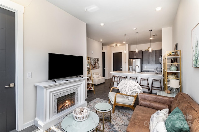 living room featuring dark hardwood / wood-style floors and a high end fireplace