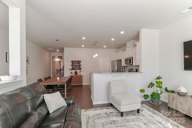 living room featuring dark hardwood / wood-style flooring