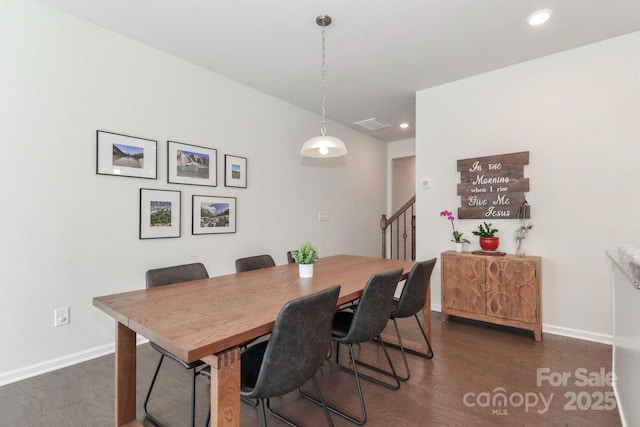 dining area featuring dark wood-type flooring