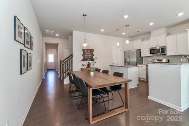 dining space with dark hardwood / wood-style flooring and sink