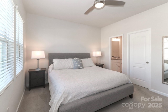 carpeted bedroom with connected bathroom and ceiling fan