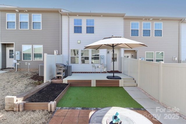 rear view of property featuring central AC and a patio