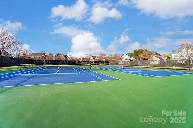 view of sport court featuring a residential view and fence