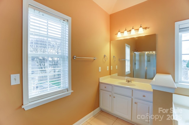 bathroom featuring baseboards, a shower stall, vanity, and tile patterned floors