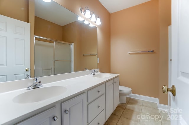 bathroom with a sink, a shower stall, toilet, and tile patterned floors