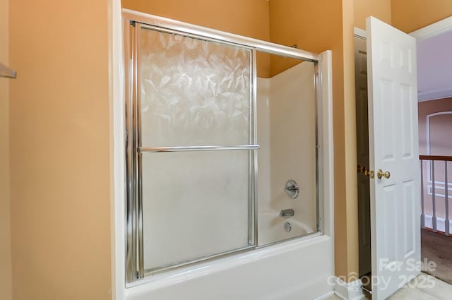 full bath featuring shower / bath combination with glass door