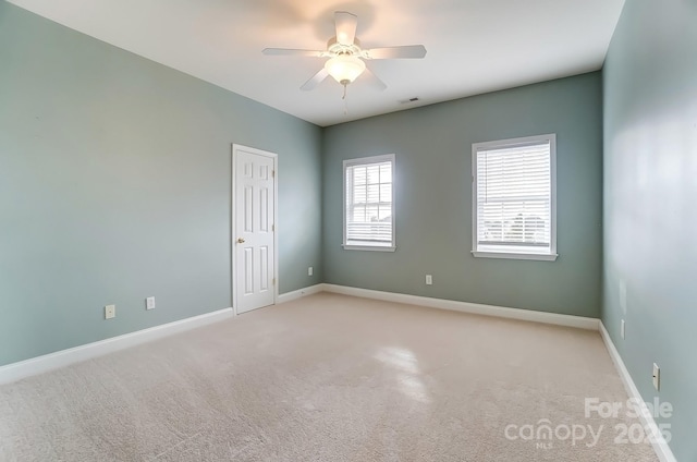 unfurnished room featuring ceiling fan, carpet floors, visible vents, and baseboards