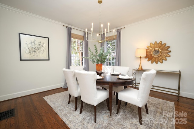 dining area featuring crown molding, dark hardwood / wood-style flooring, and a chandelier