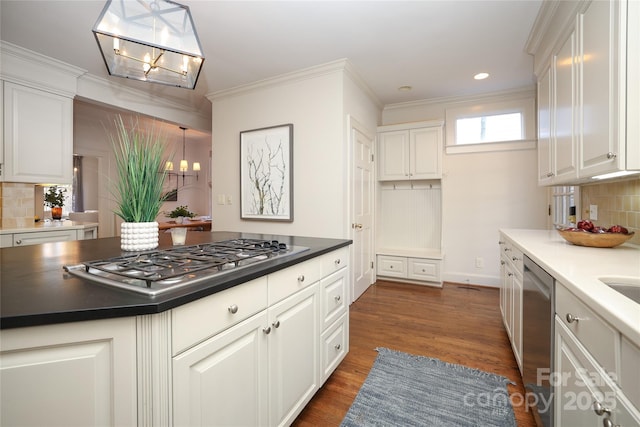 kitchen with white cabinetry, a notable chandelier, stainless steel appliances, and pendant lighting