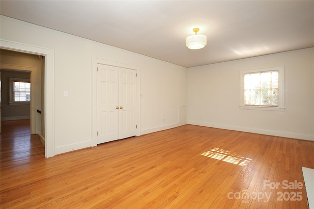 unfurnished room with light wood-type flooring